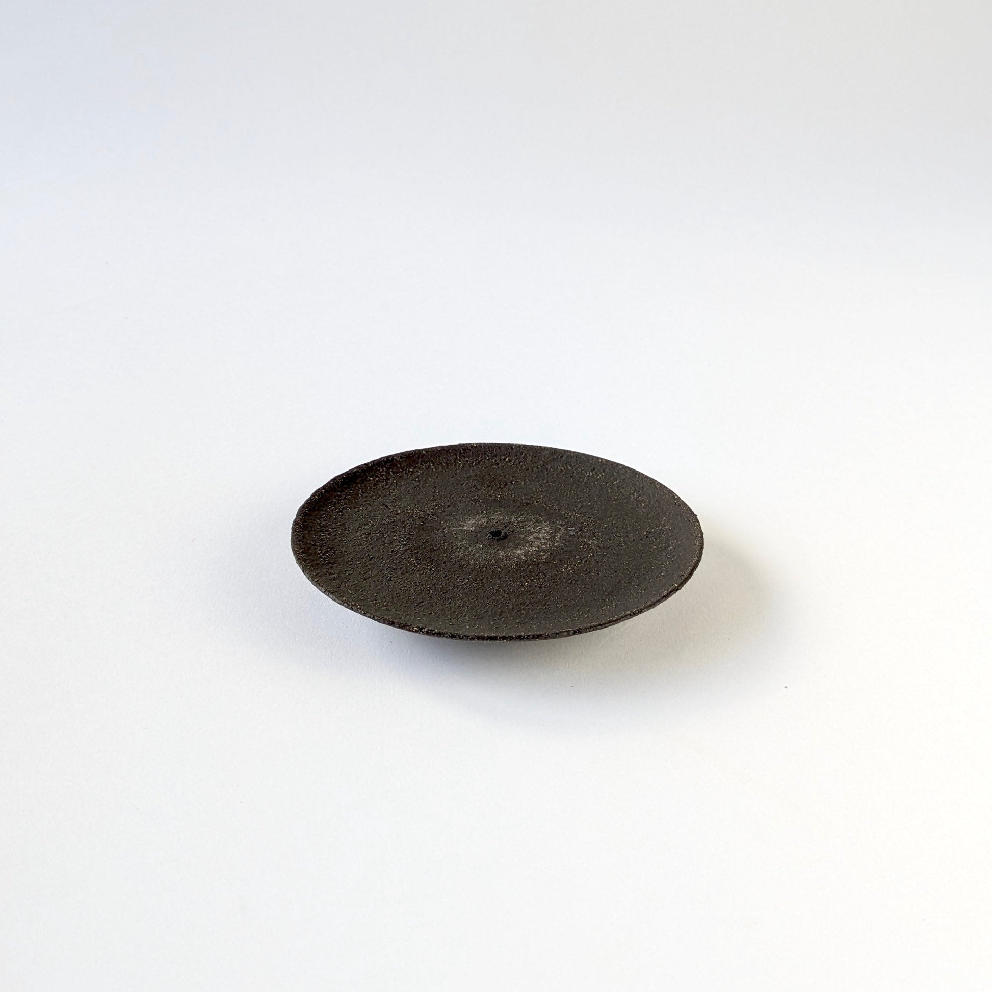 Black ceramic plate on a white background